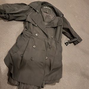 Black BCBG trench, half cuff at elbow.